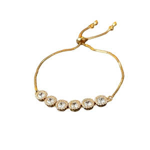Gold-plated adjustable bolo bracelet with six circular zircon stones and halo design
