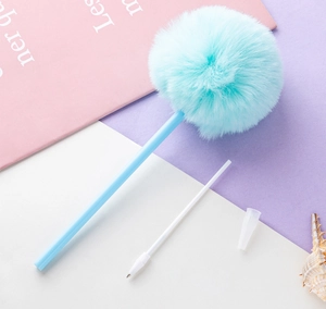 Disassembled view showing blue pom pom, plastic barrel and white ink refill of the pen