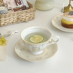 Close-up of ceramic camellia cup with cat illustration and camellia lettering inside