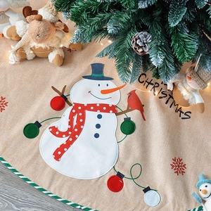 Linen Christmas tree skirt featuring Santa Claus, snowman patterns and holiday lettering