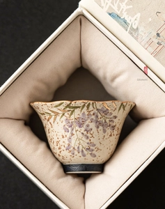 Detail of wisteria hand-painted ceramic teacup with gold-rimmed petal edge in gift box