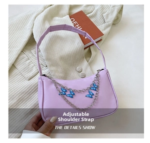 Detail of lavender baguette bag with silver double chain and blue gradient butterflies