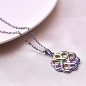Macro shot of colorful iridescent Celtic knot pendant on 18k gold plated chain