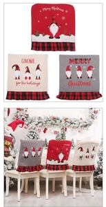 Detail view of festive Christmas chair covers with gnome patterns and plaid borders