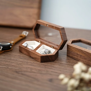 Detail of hexagonal walnut wood jewelry box with double slots and clear glass window lid