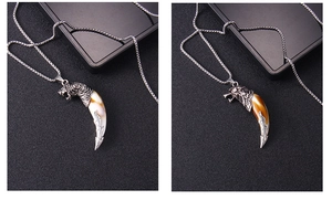Detailed close-up of tiger head pendants with faux wolf tusks in white and brown colors