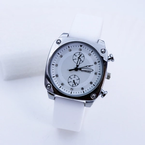 Detail of square quartz watch with rhinestone markers and soft white silicone strap