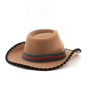 Detail of camel felt cowboy hat with red and green striped band and black whipstitch edge