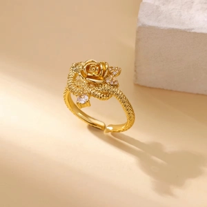 Detail of gold rose ring with sparkling zircon stones on an elegant stone pedestal