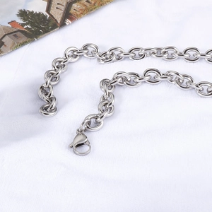 Close-up of silver stainless steel chain link necklace with secure lobster clasp detail