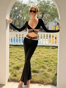 Chic black two-piece set with deep V-neck lace-up top and high waist flare pants