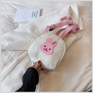 Detail of canvas mini backpack with cute 3D bunny patch and pink shoulder straps