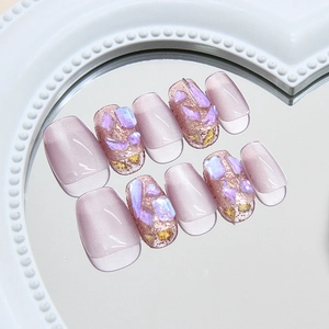 Handmade pale purple cat-eye press-on nails with sparkling rhinestones and gold foil
