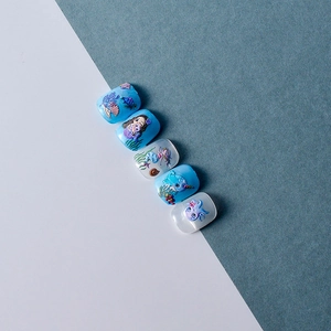 Close-up of 5D ocean-themed nail stickers with 3D embossed mermaid and sea turtle patterns