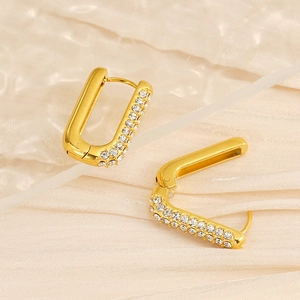 Macro view of gold plated stainless steel U-shaped earrings with inlaid clear diamonds