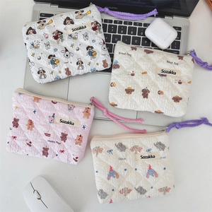 Flat lay of floral quilted mini storage bags with animal patches and braided lanyards
