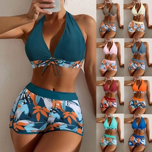 Detail of high-waist printed boyleg bikini bottom with drawstring halter neck tankini top