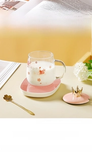 Detail of cherry blossom glass set with pink heating base and golden crown lid