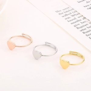 Detailed close-up of adjustable heart rings in rose gold, silver, and gold finishes