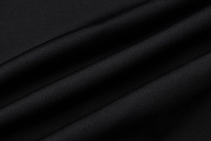 Macro detail of high-quality black mesh fabric texture for summer slip dresses