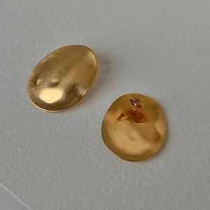 Irregular brushed gold stainless steel oval stud earrings with minimalist metal texture