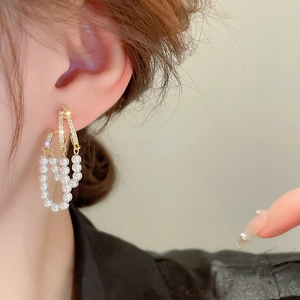 Elegant vintage gold zircon earrings with triple row faux pearl tassels on a model