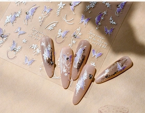 Detailed view of matte shell butterfly nail stickers with floral patterns on nude base