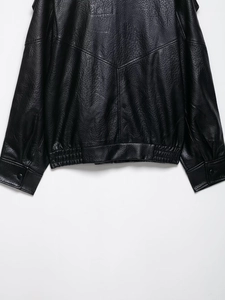 Detail of lychee pattern leather jacket showing stitching on hem and ribbed cuffs