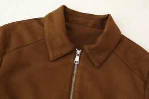 Close-up of lapel collar and zipper detail on brown suede jacket with visible stitching