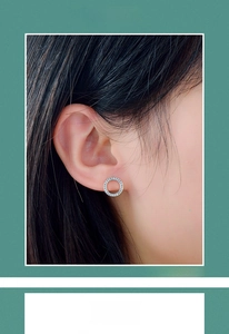 Detailed view of S925 sterling silver round stud earrings with pavé zircon crystals