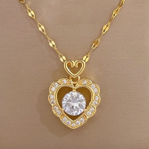 Macro shot of double heart gold necklace featuring brilliant pavé diamond accents