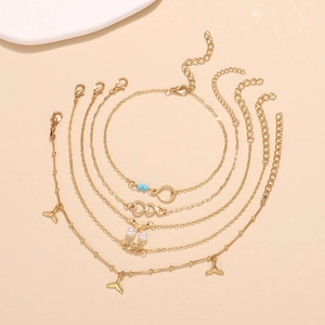 Five-piece gold anklet set with bohemian fishtail, pearl, and heart charms for beach wear