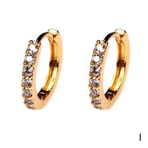 Detailed macro view of 18K gold plated huggie earrings featuring sparkling cubic zirconia