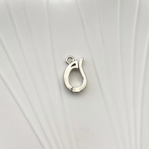 Macro detail of silver-plated pear-shaped jewelry clasp for necklace and bracelet making