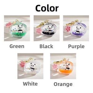 Close-up of panda liquid quicksand keychain with sakura charm in five vibrant colors