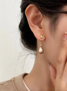 Detailed view of French vintage champagne teardrop pearl earrings with gold-plated finish