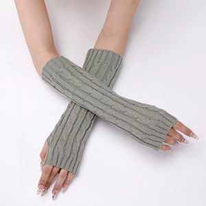 Detail of grey cable knit long fingerless gloves showing soft wool texture and patterns