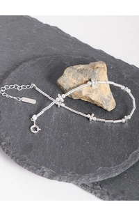 Macro shot of S925 sterling silver chain with minimalist bead and tube design