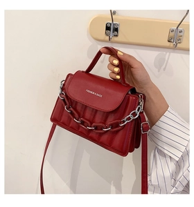 Detail of red quilted crossbody bag with resin chain strap and Fashion & Bags text