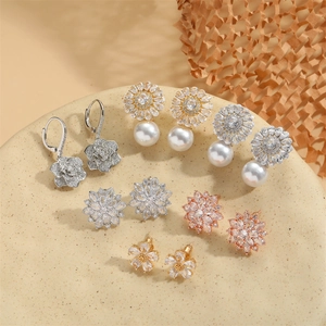 Collection of luxury vintage floral pendant earrings with pearls and zircon in warm tones