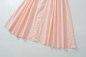 Detailed view of pink pleated fabric with high-density folds and soft textile texture