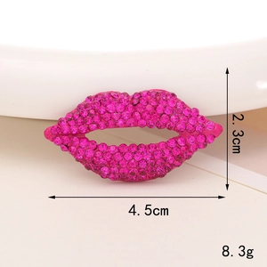 Detailed view of pink rhinestone lip brooch with measurements 2.3cm height and 4.5cm width