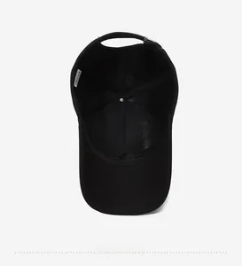 Detailed interior of black cotton baseball cap showing 100% cotton label and stitching
