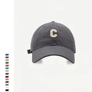 Detail of dark grey baseball cap featuring premium C letter patch and canvas texture
