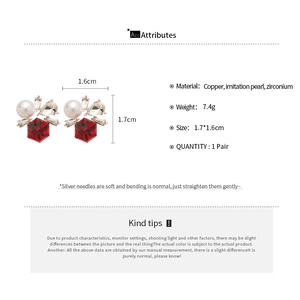 Macro view of flower earrings with pearls and red stones showing detailed dimensions