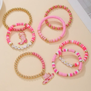 Detailed flat lay of pink western cowgirl clay bead bracelets with boots and hat charms