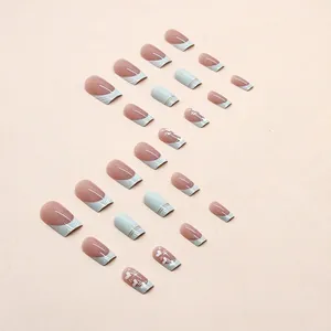 Press-on coffin nails with heart designs and gold foil in pink, blue, and white tones