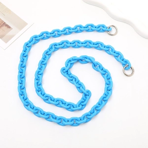Macro view of bright blue acrylic crossbody chain with silver metal ring connectors