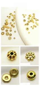 Detailed tile display of antique gold snowflake spacers and beads for DIY jewelry making