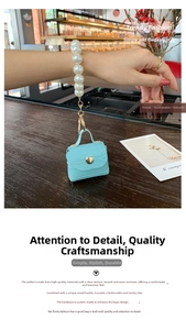 Macro shot of light blue croc-embossed leather mini bag with large pearl handle
